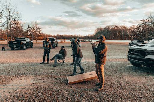 Image of men at a tailgating event playing some games at dusk