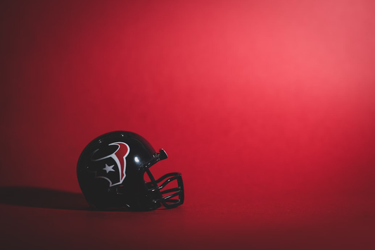 Image of a Houston texans helmet on a red gradient background