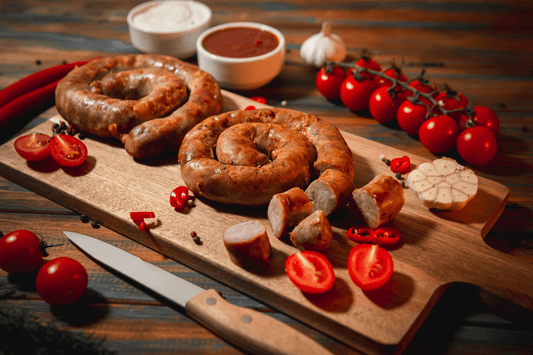 Sausage sliced on a cutting board in dim light