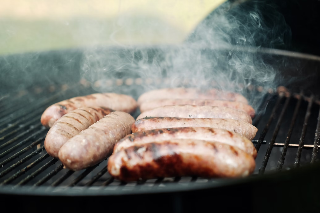 Sausages being grilled on a circular grill